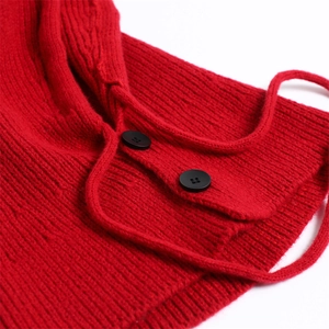 Detailed close-up of thick red knit balaclava with black buttons and drawstrings