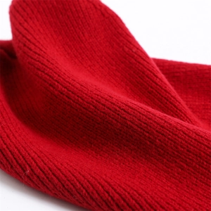 Macro shot of red knit balaclava showing vertical stripe texture and wool material
