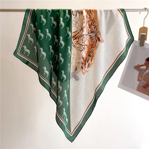 Detail of silk-like scarf with zebra print and forest landscape art patterns