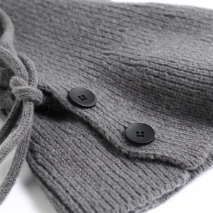 Detail of grey ribbed knit balaclava showing black buttons and drawstring texture