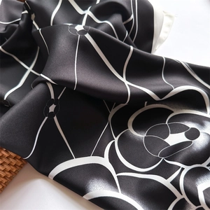 Close-up of elegant black and white camellia floral print on twill silk square scarf