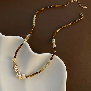Handmade beaded necklace with shells and brown resin beads on gold stainless steel chain