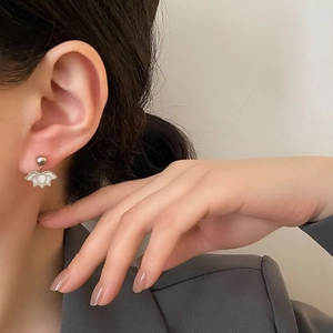 Elegant lotus pendant earrings in silver stainless steel on model for a refined style