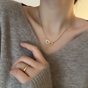 Elegant double-heart interlocking titanium steel necklace shown on a model