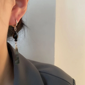 Long black drop earrings with dark trapezoid pendant in a minimalist oriental style