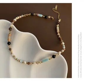 Detailed close-up of ethnic style beaded necklace with natural pearls and agate on ceramic