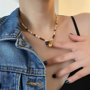 Retro beaded choker necklace featuring a golden water drop pendant with star engraving