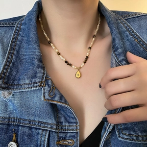 Bohemian teardrop necklace with tiger eye beads and shell pearls for a vintage layered look