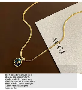 Detailed shot of titanium steel necklace with abalone shell floral pendant and gold chain