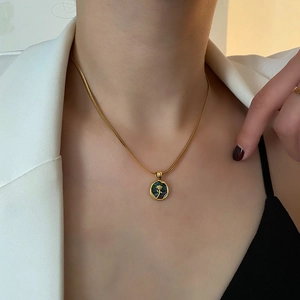 Elegant gold snake chain necklace with abalone shell rose pendant on female model
