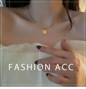 Close-up of gold titanium steel square pendant necklace with V engraving on model
