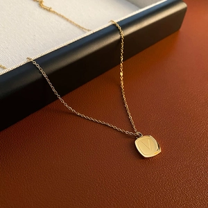 Minimalist gold square pendant necklace with engraved letter V and fine chain for women