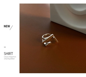 Macro detail of geometric silver minimalist ring on premium brown leather surface