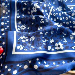 Detail of navy blue silk square scarf showing delicate heart and polka dot prints