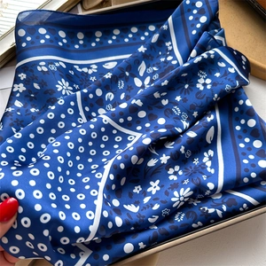 Elegant navy blue silk scarf with white heart and polka dot patterns in a gift box
