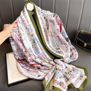 Detail of silk-like scarf with elegant flower and bird patterns in vintage Chinese style