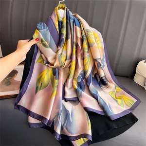 Detailed view of the elegant floral print and smooth silk texture on this large scarf
