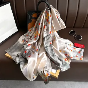 Elegant ink floral faux silk scarf draped on a bag showing smooth satin texture