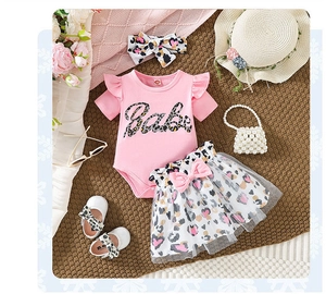 Flat lay of pink baby romper with Babe print, leopard tutu skirt, headband and shoes