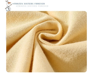 Close-up of light yellow knit fabric showing soft texture and premium cotton blend quality