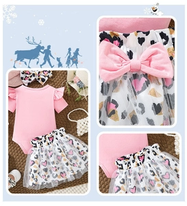 Detail of pink baby bodysuit with heart leopard print tutu and large bow waist decoration