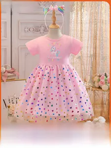 Detail of pink unicorn dress with colorful heart sequins and mesh tutu layers