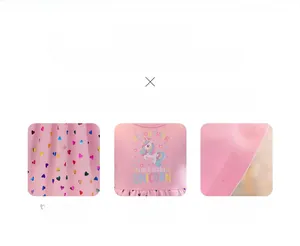 Detail of pink tutu dress featuring unicorn print and colorful heart mesh fabric texture