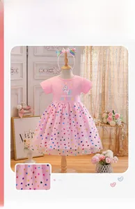 Detail of pink cotton bodice with unicorn print and colorful sequin heart tulle skirt