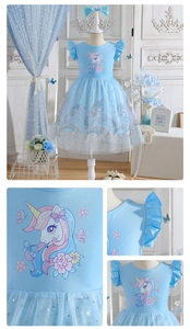 Detail of blue unicorn dress showing glitter star tulle and sequined cat ear headband