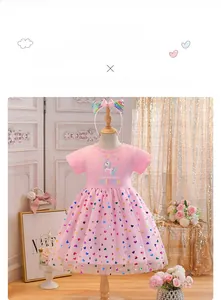 Close-up of pink tulle skirt with colorful heart sequins and unicorn print details