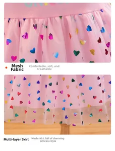Detail of pink girls tulle dress with gradient heart patterns and multi-layered skirt