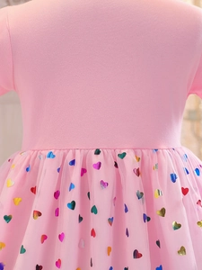 Pink girl's tulle dress featuring colorful heart sequins and cotton knit top