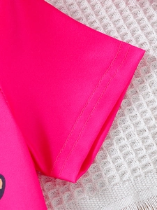 Detail of rose pink short sleeve with durable double-needle stitching on high-elastic fabric