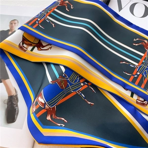 Deep blue and yellow silk skinny scarf with vintage horse print on fashion magazine