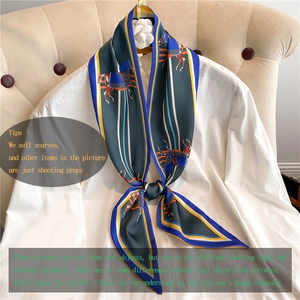 Detail of British horse print silk scarf tied on a white shirt with satin finish