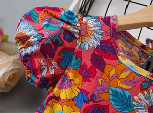 Macro view of floral pattern and puff sleeve detail on a vibrant rose pink summer dress