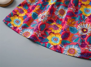 Detailed close-up of floral print cotton dress hem with high-quality stitching