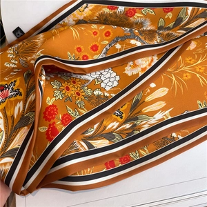 Golden silk-like scarf with sunflower and floral prints and striped edges for hair or neck