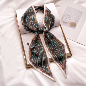 Elegant skinny silk scarf with colorful letters and retro border on white magazine
