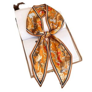 Floral orange satin skinny scarf with vintage botanical patterns tied in a bow knot