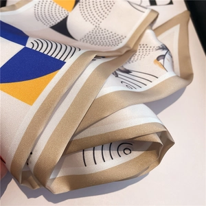 Narrow silk scarf with colorful flower block patterns and a glossy satin finish