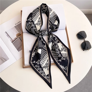 Elegant black and white geometric silk-like twilly scarf styled with sunglasses