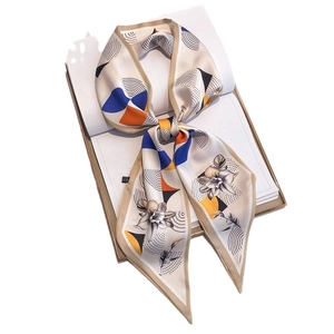 Floral geometric silk twilly scarf with block patterns tied on a white book