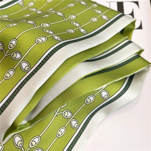 Elegant grass green silk scarf with geometric plant patterns and soft satin luster