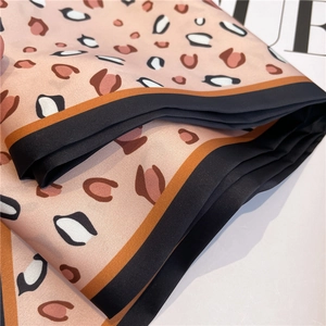 Pink leopard print skinny silk scarf with black contrast border and satin finish