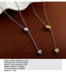 Detail of titanium steel heart pendant necklaces on premium dark brown leather background