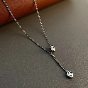 Minimalist silver titanium steel heart necklace featuring a cylindrical bead and dual-textured chain