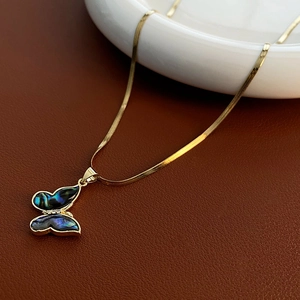 Elegant gold butterfly pendant necklace with iridescent abalone shell on a snake chain