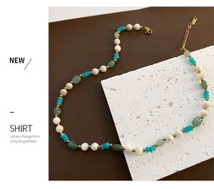 Detail of bohemian strawberry crystal beaded necklace with gold lobster clasp