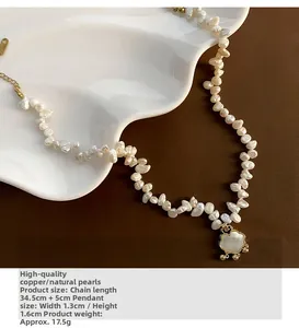 Detail of baroque pearl necklace with cloud shell pendant on a white ceramic tray